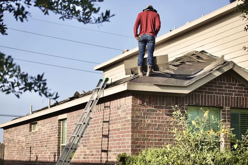 Professional roofer working on a residential roof in Rowland